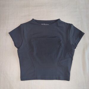 Women's cropped gray workout top with built in bra
